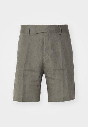 Shorts en lin kaki avec une coupe droite, un devant plat et des poches latérales. Présentent une texture subtile et des lignes épurées. Pas d'accents matériels visibles.