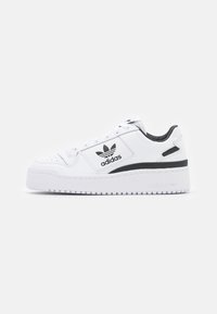 White Adidas sneaker with black logo and stripe, thick sole, lace-up design, and padded collar against plain light background.