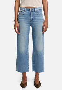 Ljust blå vida jeans med hög midja, fransad nederkant och femficksdesign. Tillverkade av denim med en medelhög tvätt och subtila blekningar.