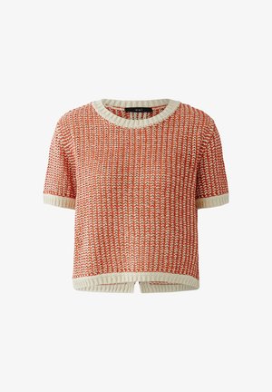 Short-sleeve knit top with orange and white zigzag pattern, cream ribbed crew neckline, sleeve cuffs, and hem with front slit detail.