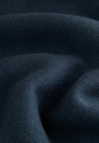 Navy blue knitted fabric with a textured weave, featuring soft, smooth contours and subtle sheen. Ideal for clothing or accessories.