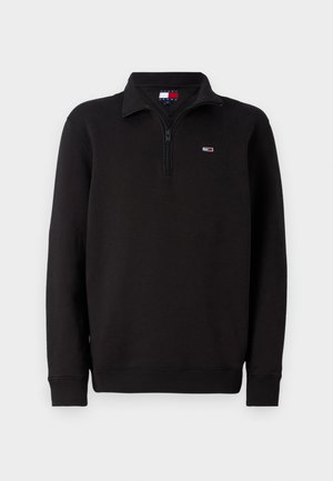 Schwarzer Fleece-Pullover mit halbzipper, gerippten Bündchen und kleinem Logo auf der linken Brust. Verfügt über ein klassisches Kragen-Design.