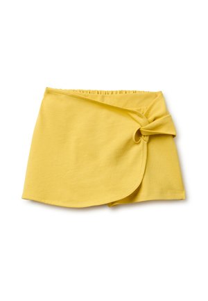 Jupe portefeuille jaune avec taille élastique et détail de nœud sur le côté, confectionnée en tissu doux et léger, présentée sur fond blanc.