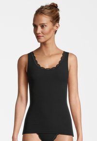 Black ribbed tank top with a scalloped lace neckline. The fabric appears soft and stretchy, suitable for layering or casual wear.