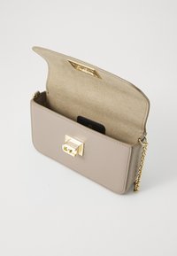 Beige faux leather handbag with a smooth texture, gold hardware, and a chain strap. Features a magnetic closure and soft interior lining.
