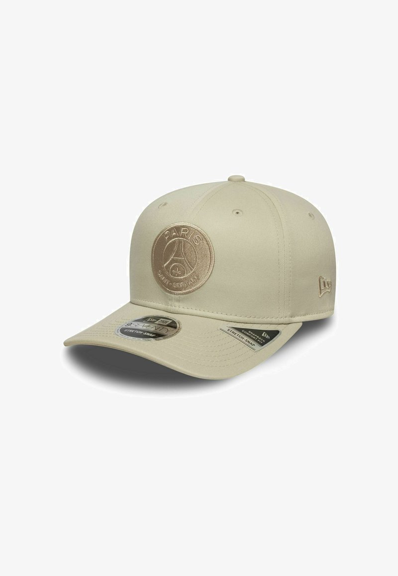 Casquette de baseball beige avec un logo brodé rond portant l'inscription "PARIS" et un graphique. Elle dispose d'une visière courbée et d'une fermeture snapback.
