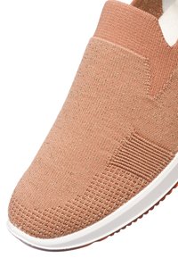 Slip-on shoe in light coral fabric with a textured finish and a white rubber sole. Features elastic side accents for easy wear.