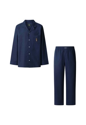 Námorníckomodrý pyžamový set vyrobený z mäkkej tkaniny. Dlhý rukáv s gombíkovou košeľou a náprsné vrecko s vyšívaným detailom. Voľné nohavice s elastickým pásom.