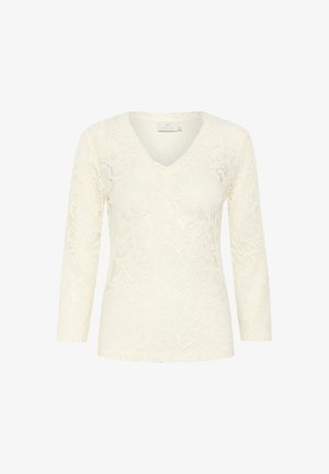 Top in pizzo color crema con scollatura a V, maniche a tre quarti, intricati motivi floreali e dettagli di superficie texture.