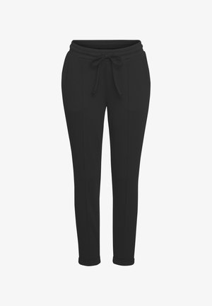 Schwarze Sweatpants mit einem Kordelzugbund, schmal zulaufenden Beinen und sichtbaren Seitennähten. Hergestellt aus einem weichen, leichten Stoff.