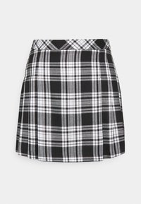 Svart och vit rutmönstrad kjol med plisserad design och en åtsittande midja. Tillverkad av ett vävt tyg med en mjuk textur.