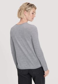 Grijze langarmshirt met een gladde textuur, ronde hals en subtiele naaddetails, gecombineerd met donkere jeans, gezien van achteren.