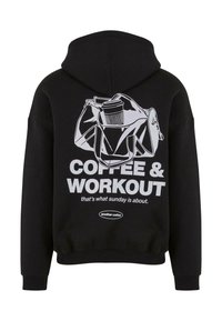 Zwarte pullover hoodie met een graphic van een tas en de tekst: "KOFFIE & WORKOUT" in het wit, met een casual pasvorm en een zachte textuur.