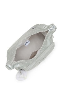 Metallic silver zippered pouch with smooth texture, interior pocket, and a fluffy charm attached to the zipper pull. Brand tag visible inside.