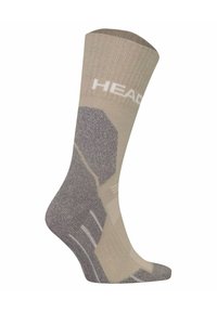 Beige strumpa med texturerade grå detaljer och vit "HEAD"-logotyp; har en förstärkt häl och tå samt en bekväm, åtsittande design.