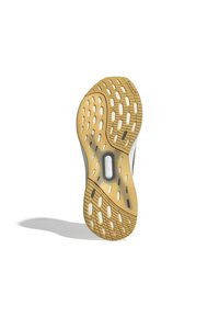 Gummisål til sneakers med honningfarvet slidbane, der har et fleksibelt design, små riller og en eksponeret støddæmpningsenhed.