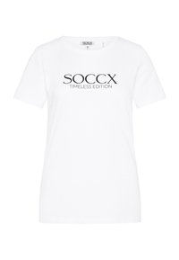 Camiseta de algodón blanca con mangas cortas y cuello redondo. Texto impreso en negro que dice "SOCCX TIMELESS EDITION" en la parte frontal.