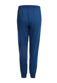 Pantalones deportivos azul marino con cinturilla elástica, piernas ajustadas y cremalleras en el tobillo. Textura suave sin patrones o acentos visibles.