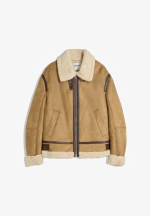 Shearling jacket in light brown suede with a cream faux fur collar and cuffs, front zip closure, and brown leather accents.