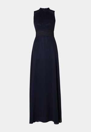 Navy floor-length dress with a halter neck, pleated bodice, and decorative lace waistband. Smooth fabric with a draped, elegant silhouette.