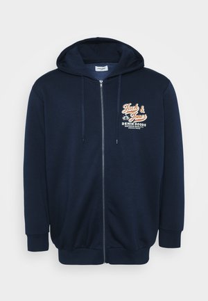 Navy zip-up hoodie with a front kangaroo pocket, adjustable drawstring hood, and a printed logo on the chest in orange and white.