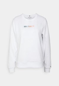 Sudadera blanca con puños y dobladillo acanalados. Presenta "HILFIGER" en texto multicolor en el pecho. Tejido suave, diseño casual.