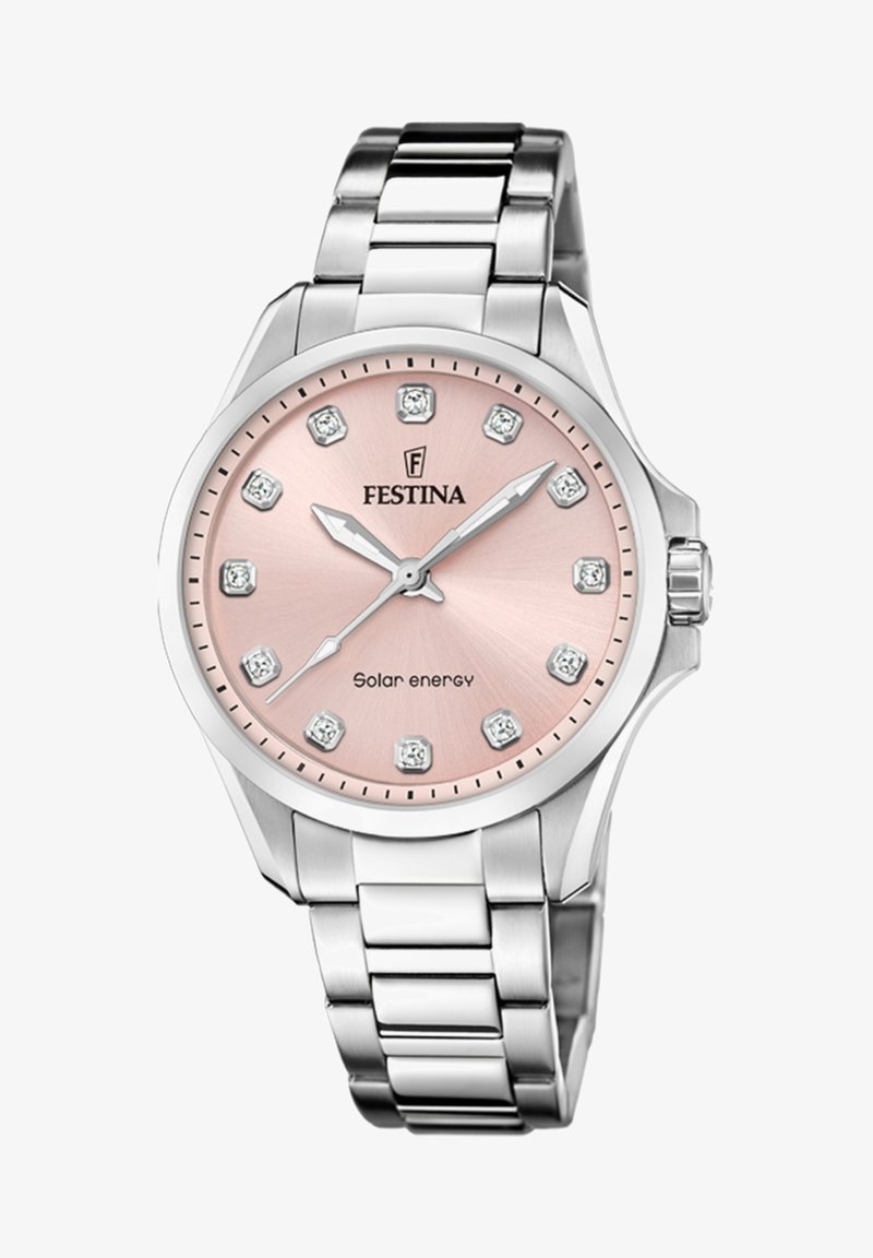 Sudraba nerūsējošā tērauda pulkstenis ar apaļu rozā ciparnīcu, kurai ir dimanta formas stunda rādītāji un saules enerģijas uzraksts. Metāla ķēdes aproce.