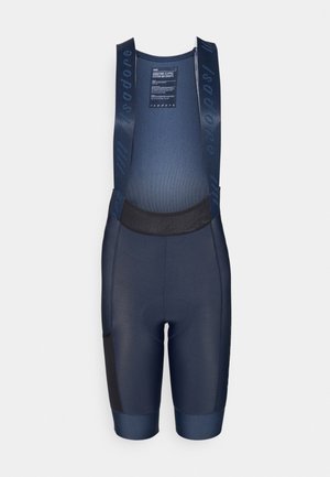 Navy cycling bib shorts made of stretchy fabric, featuring a padded seat, mesh upper, and black accents on the legs and side pockets.