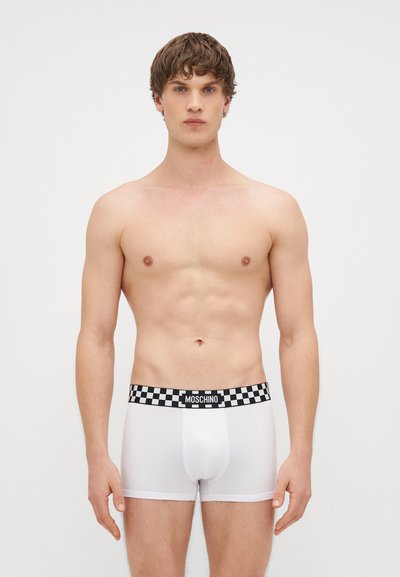 Men's white boxer briefs with a black and white checkered elastic waistband featuring "MOSCHINO" logo. Smooth fabric, fitted design.