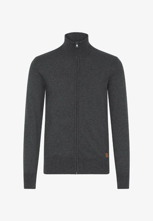 Tumehall sinine tõmblukk-sviiter kõrge kaelusega, valmistatud pehmest kvaliteetsest kudumist. Omab pikki varrukaid ja väikest beeži logotagi alumisel küljel.