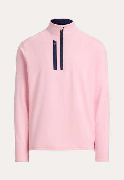 Φούτερ σε ανοιχτό ροζ με μακρύ μανίκι, λεπτομέρεια με ναυτικό μπλε φερμουάρ στον ψηλό γιακά και πρόσθετη κάθετη τσέπη στο στήθος με φερμουάρ.