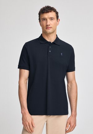 Navy blue polo shirt made of smooth fabric with a collar and three-button placket; features a small logo on the left chest.