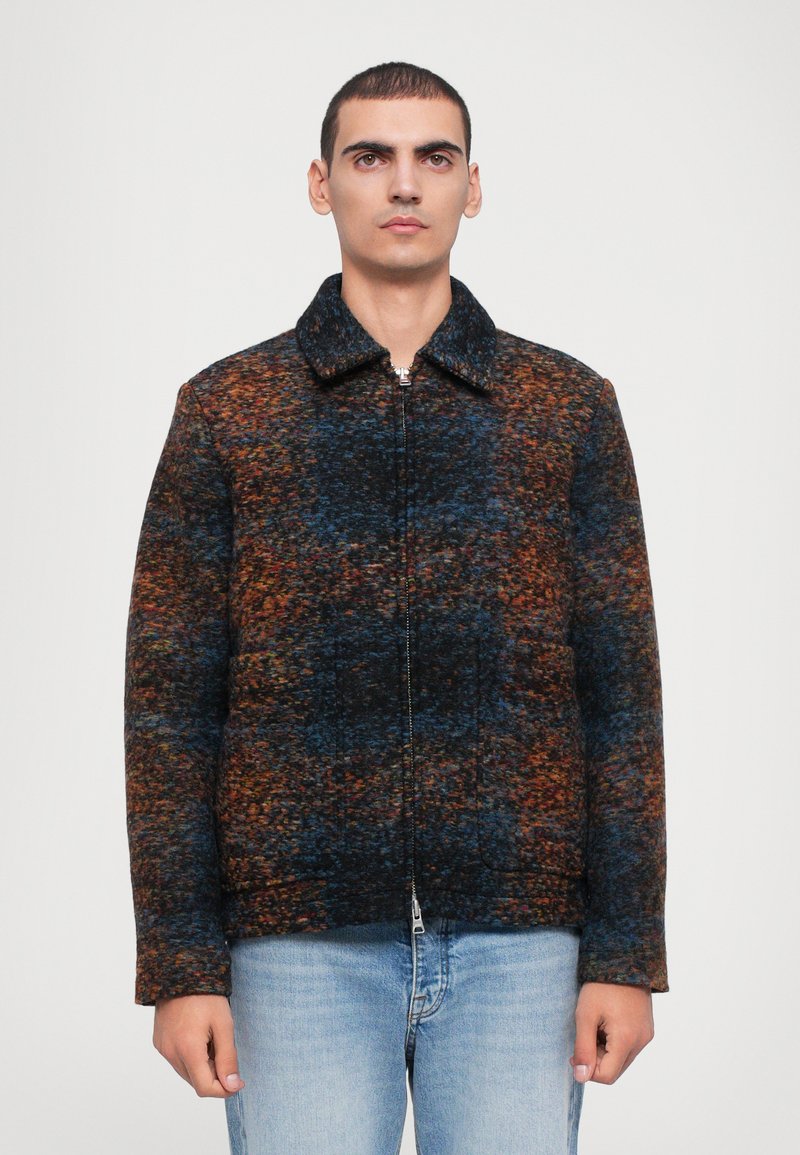 Zip-up jacket in multicolored fabric featuring dark blue, orange, and brown textures; has a pointed collar and two side pockets.