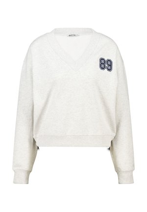 Cropped, light grey sweatshirt with a V-neck. Features navy blue number "89" embroidered on the left chest. Soft fabric and ribbed cuffs.