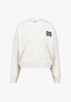 Cropped, light grey sweatshirt with a V-neck. Features navy blue number "89" embroidered on the left chest. Soft fabric and ribbed cuffs.