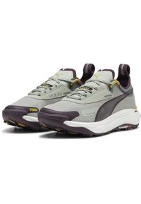 Gray and purple athletic shoes with a mesh upper, textured accents, yellow details, and a thick white sole featuring durable black tread.