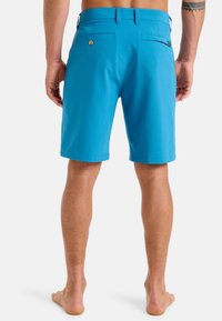 Blue, knee-length shorts, made from lightweight fabric. Includes two back pockets, one with button closure, and a flat waistband.