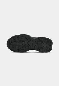 Black sneaker sole with textured grip patterns, oval accents, and "REPLAY" branding in the center midsole area.
