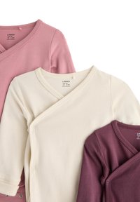 Three long-sleeve baby bodysuits in pink, cream, and burgundy, featuring wrap designs and snap closures. Soft cotton fabric.
