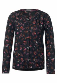 Svart blus med långa ärmar, med ett lövmönster i rosa, orange och vitt. Plisserad halsringning, rynkad nederkant och lättviktsmaterial.