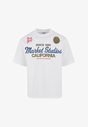 Biała bawełniana koszulka z niebieskim i czerwonym napisem: "Market Studios" i "Kalifornia", z dodatkowymi grafikami oraz okrągłym logo z boku.