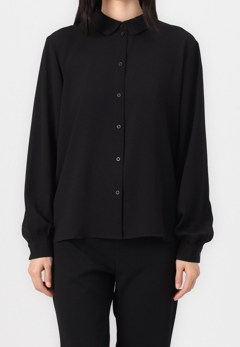 Black, long-sleeve blouse with a collared neckline, button front, and loose fit; soft texture; long sleeves gathered at cuffs.