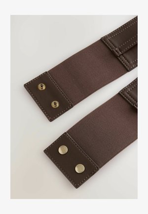 Brown fabric straps with leather accents, featuring gold hardware and contrasting stitching, flat and rectangular in shape.