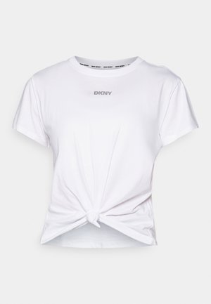 White cotton t-shirt with short sleeves, featuring a knotted hem and "DKNY" logo in rhinestones on the chest. Smooth texture.