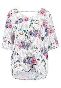 Top con motivo floreale in tessuto leggero. Caratterizzato da una base bianca con pois neri, vestibilità ampia, maniche corte e orlo arrotondato.