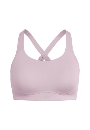 Brassière de sport rose clair avec une finition lisse, des bretelles larges et un dos croisé. Présente un marquage discret en bas.