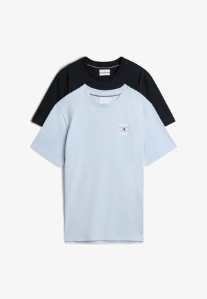 Δύο κοντομάνικα T-shirts με στρογγυλή λαιμόκοψη, ένα ανοιχτό μπλε με μικρό λογότυπο Tommy Hilfiger στο στήθος που επικαλύπτει ένα απλό μαύρο T-shirt.