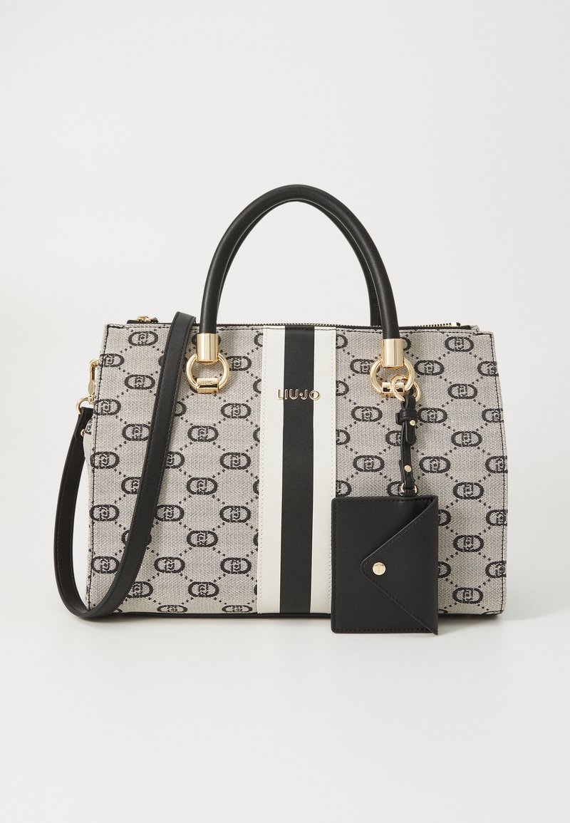 Canvas handbag with a gray pattern, black and white stripes, gold hardware, dual handles, and a detachable black cardholder.