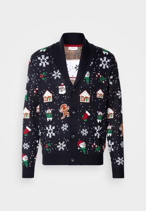 Cardigan noir avec des motifs hivernaux incluant le Père Noël, des maisons, des flocons de neige et des bonhommes en pain d'épice. Texture tricotée avec fermeture à boutons.