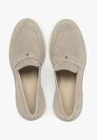 Beige suede loafers featuring a stitched design, smooth texture, and a decorative accent. Slip-on style with a soft inner lining.